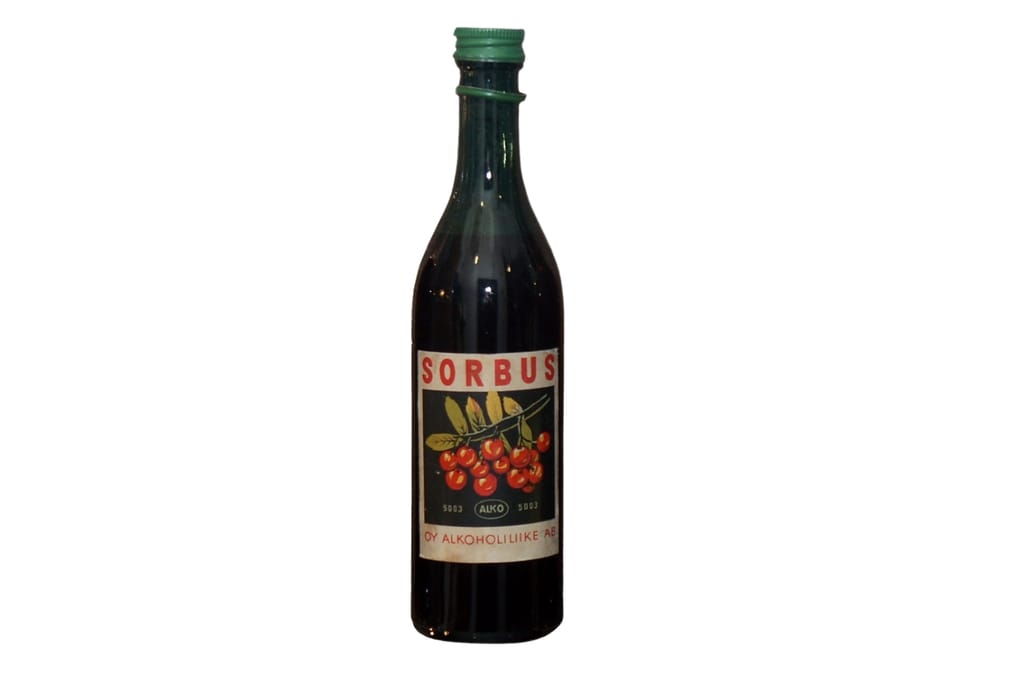 Vanha Sorbus-pullo, jonka etiketissä on punaisia pihlajanmarjoja.